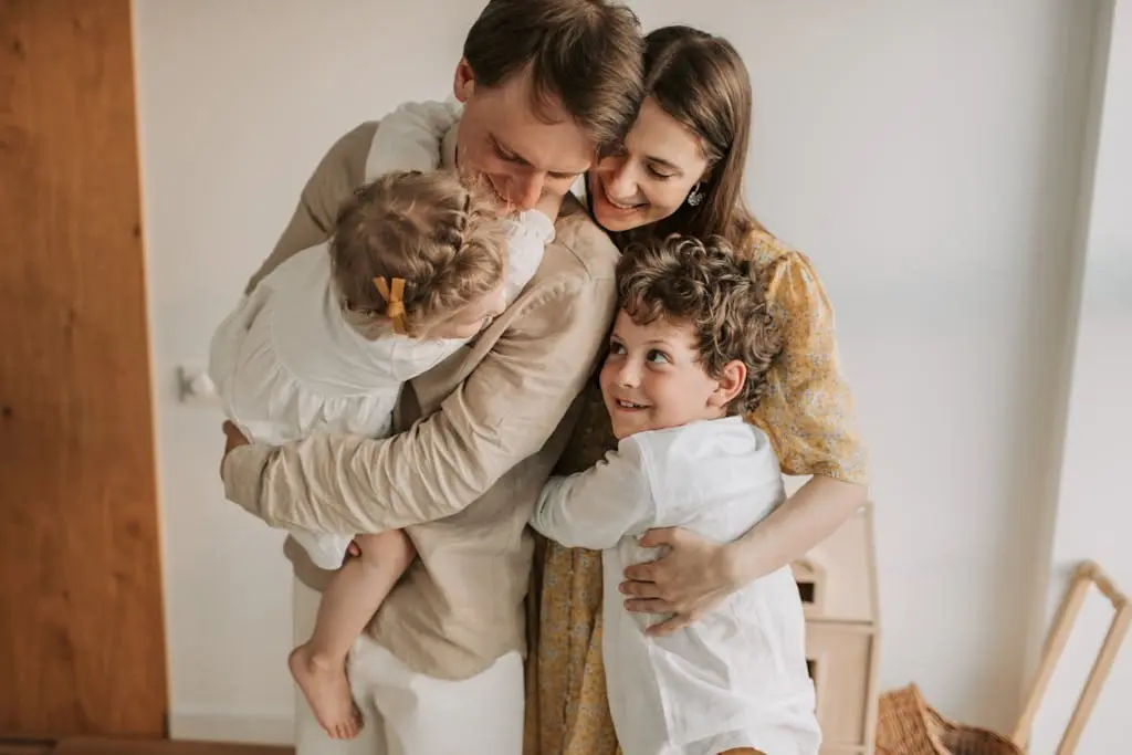 A heartwarming scene of a family hugging indoors, showcasing love and togetherness.