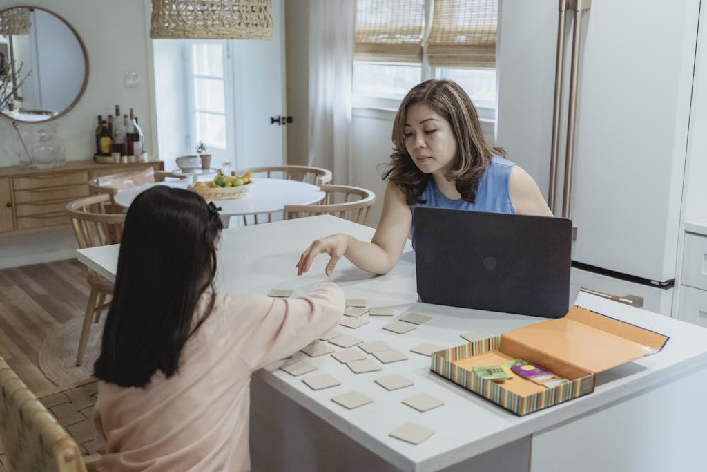 Mother and daughter enjoying a memory game together, indoors on a casual day.